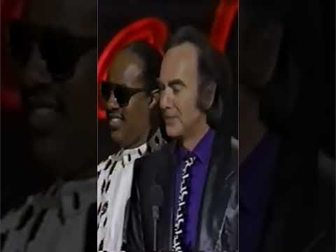 Stevie Wonder presents Neil Diamond with the Merit Award from the American Music Awards